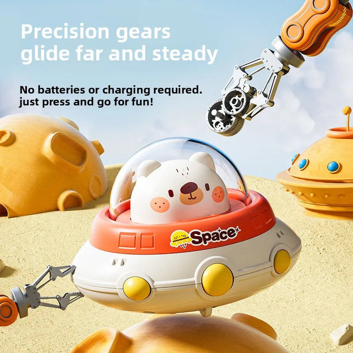 Polar bear UFO toy beside an illustration of its battery-free gear mechanism.