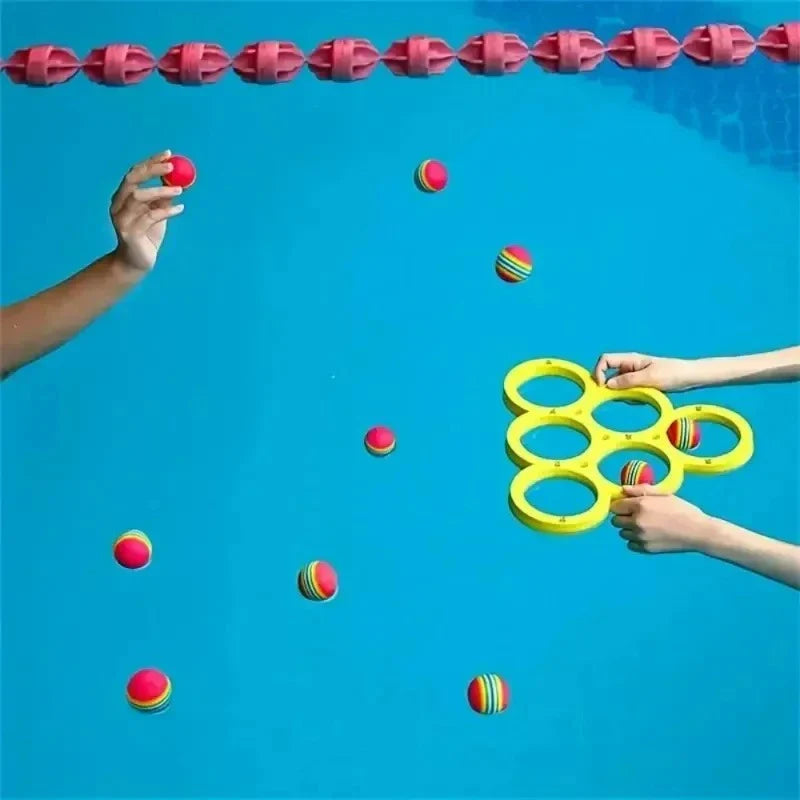 Players tossing colorful balls toward a yellow ring target in a swimming pool