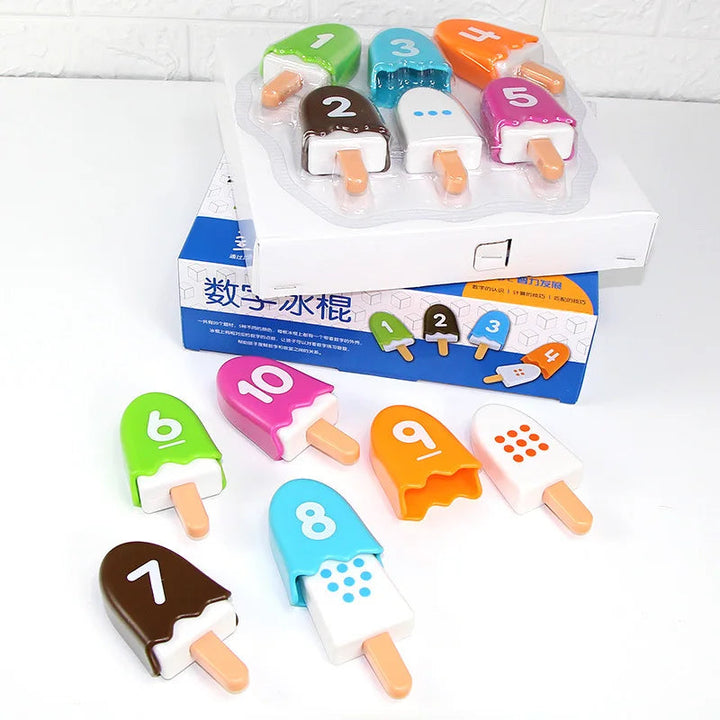 Colorful numbered popsicles and dotted counting pieces arranged beside the open box