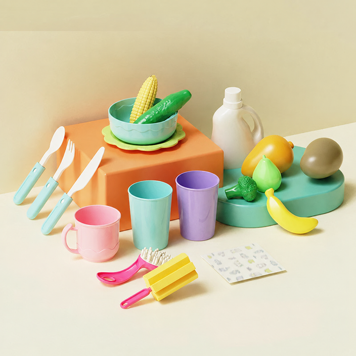 Colorful play food, cups, plates, utensils, and dishwashing accessories arranged together
