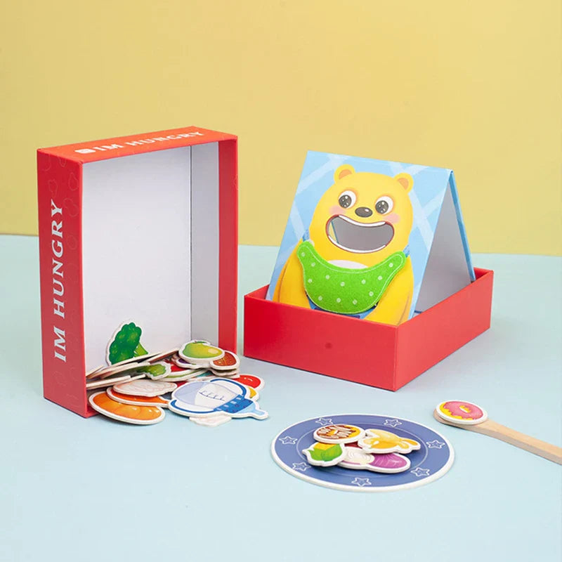 Yellow animal feeding board in a red tray with flat food pieces, a play plate, and a spoon