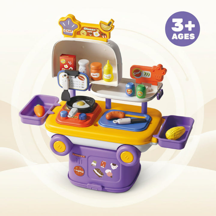 Open purple play kitchen with a toy pan, utensils, play food, and side trays