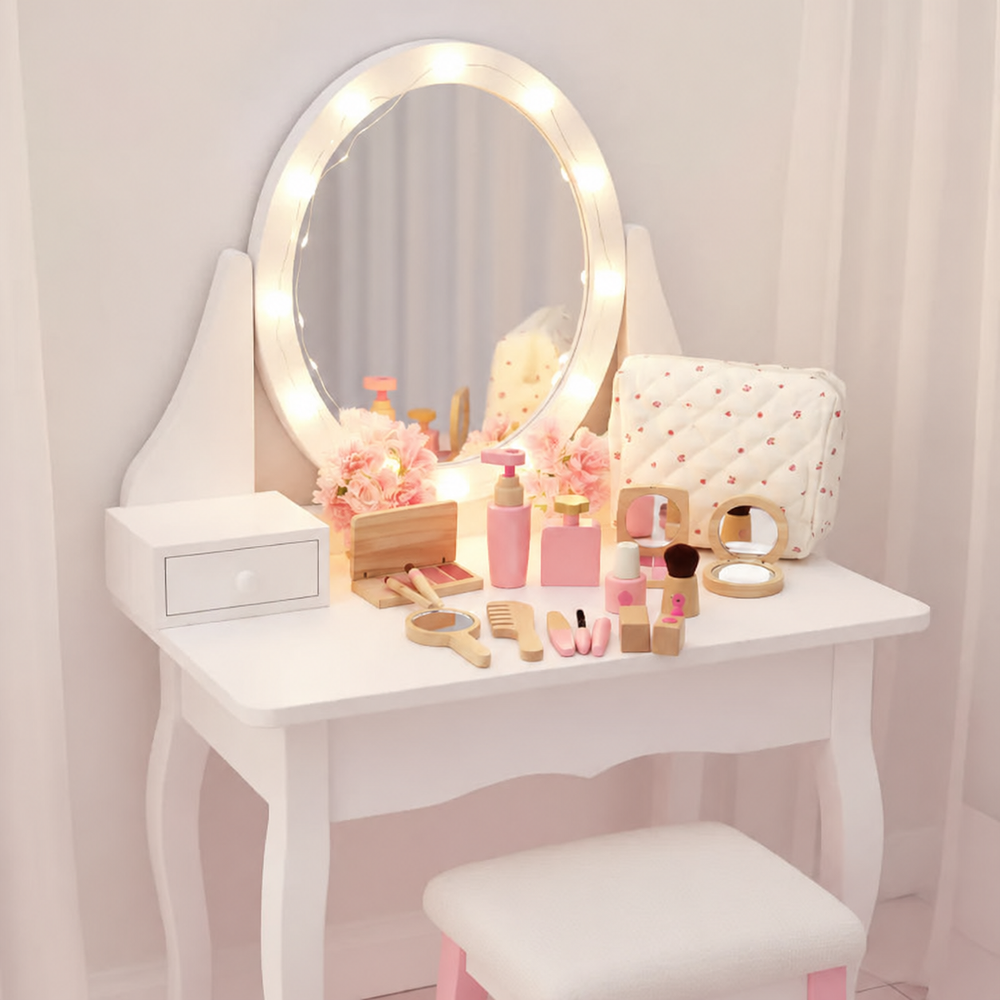 Wooden pretend makeup accessories arranged on a white vanity beneath a large mirror