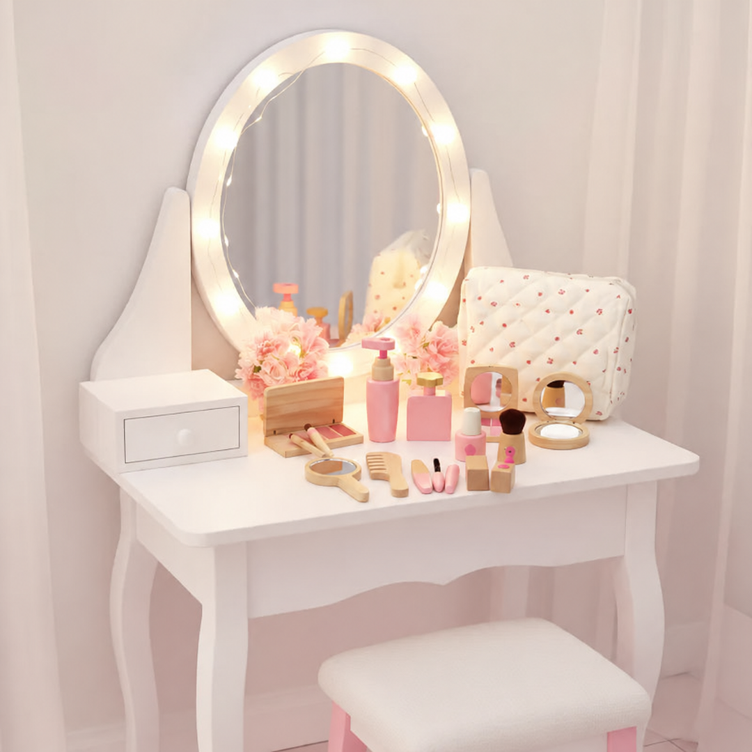 Wooden pretend makeup accessories arranged on a white vanity beneath a large mirror