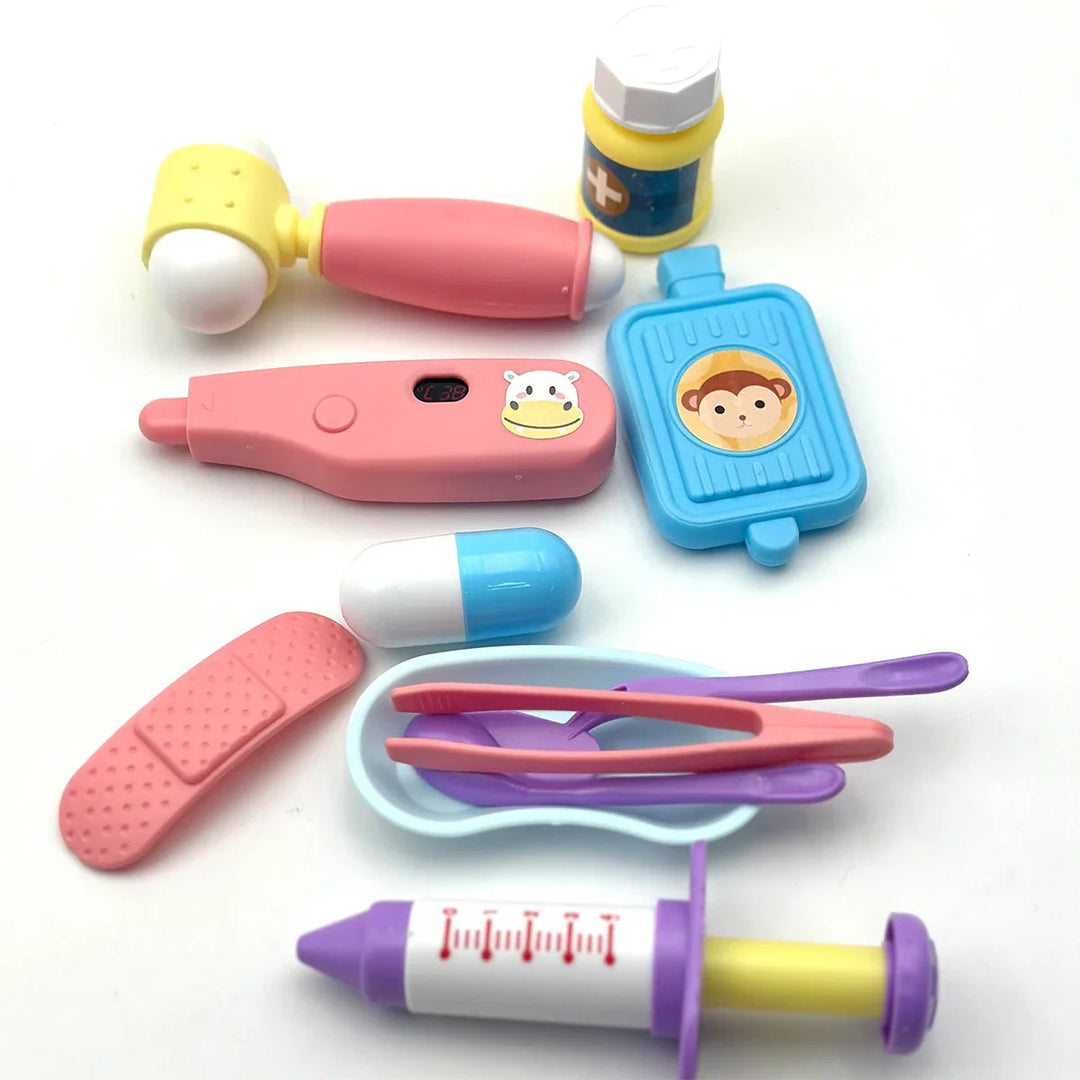 Pretend medical tools arranged with tweezers and purple utensils resting in a light blue tray