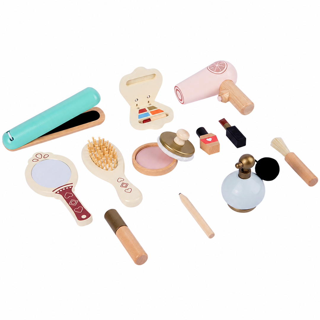 Wooden pretend styling and makeup tools laid out with a brush, mirror, perfume bottle, and straightener