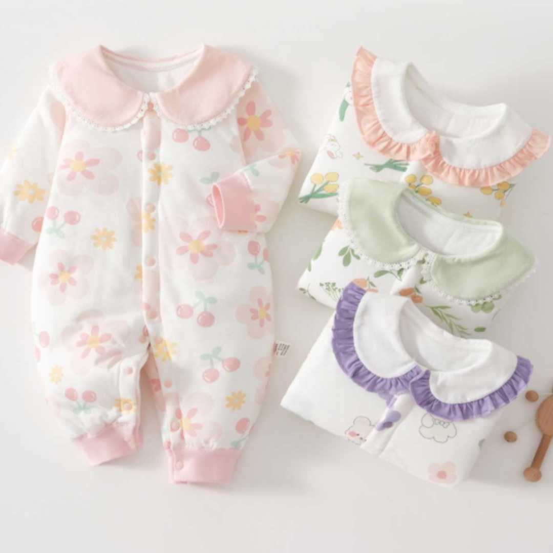 Printed baby pajamas with rounded collars and pink, green, or purple trim