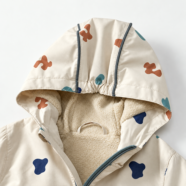 Close-up of the rain jacket hood with cream textured lining and dark trim.