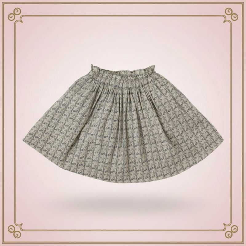 Flared printed skirt with an elastic waistband displayed against a pink decorative background