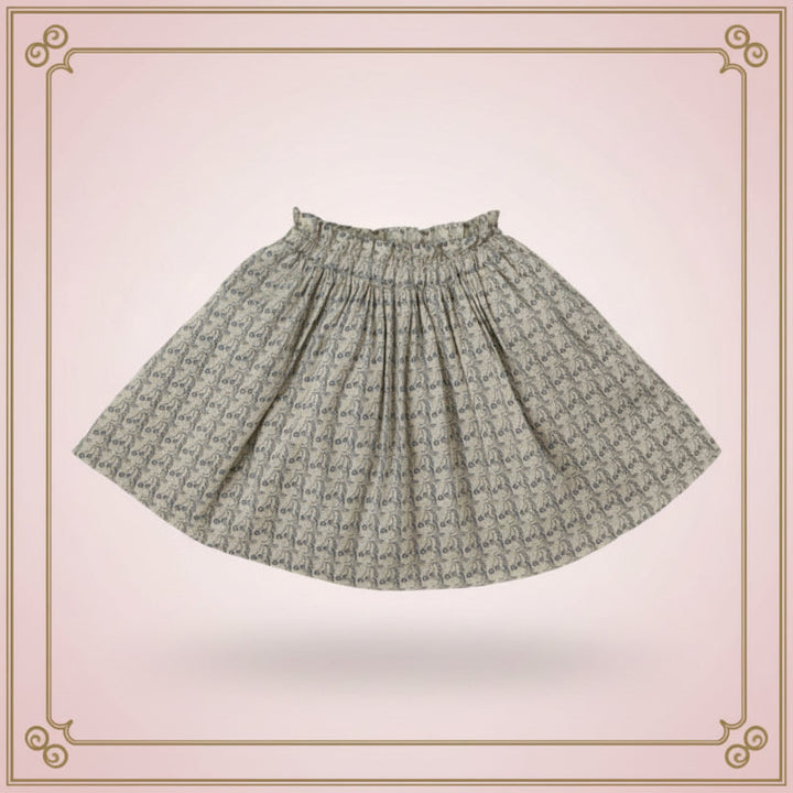 Flared printed skirt with an elastic waistband displayed against a pink decorative background