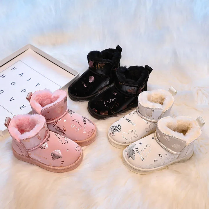 Pairs of printed snow boots in pink, black, and beige with plush-lined openings