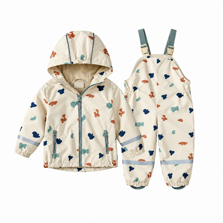 Cream hooded rain jacket and matching bib-style pants with a colorful abstract print.