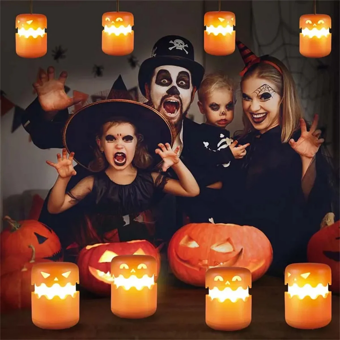 Costumed group with pumpkin lanterns hanging overhead and arranged on a table