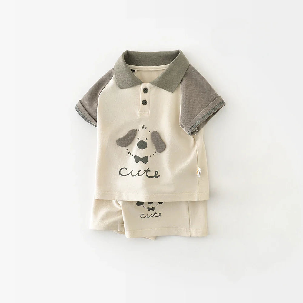 Ivory baby polo with gray sleeves and a puppy print, shown over folded matching shorts