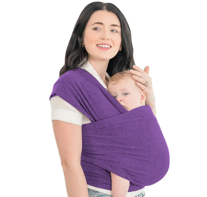 Purple baby wrap worn by a parent carrying a baby at the front