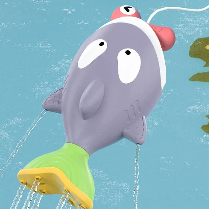 Purple bath fish with a green-and-yellow tail releasing streams of water