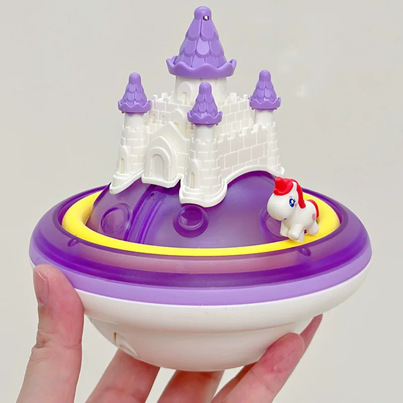 Purple unicorn castle bath toy held in one hand
