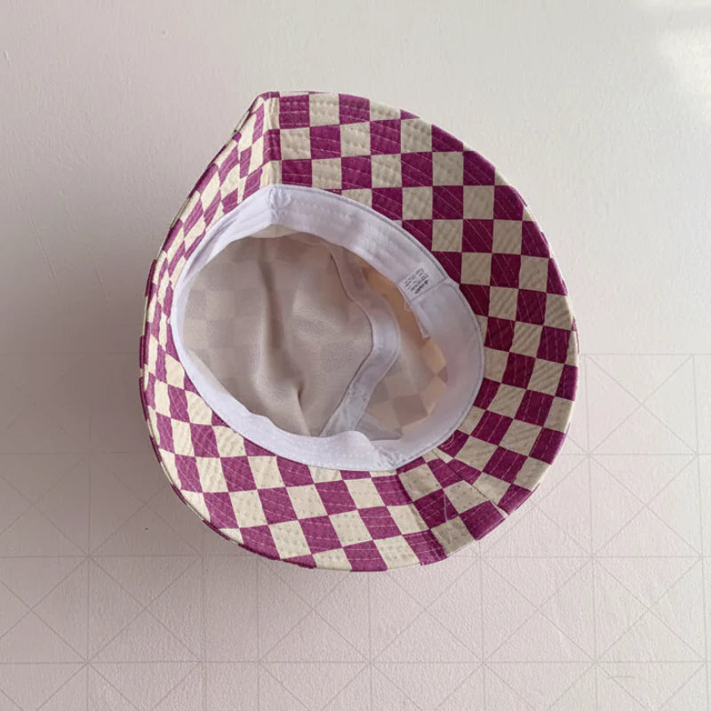 Inside view of the purple checkered bucket hat showing the light-colored interior