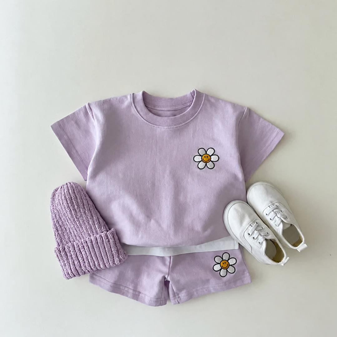 Purple daisy T-shirt and matching shorts styled with a knit hat and white shoes