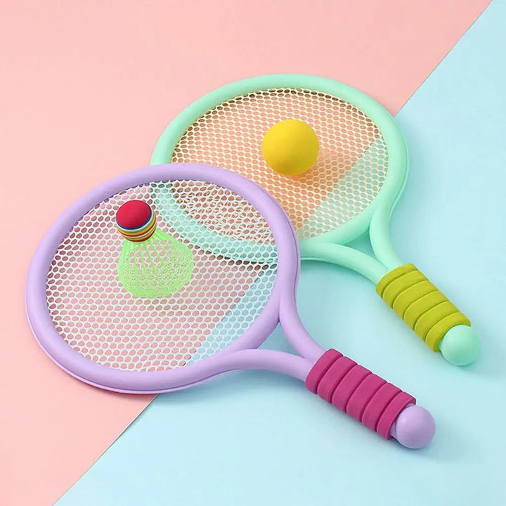 Purple and green rackets with a yellow ball and green shuttlecock