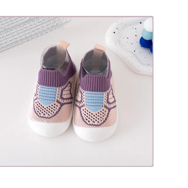 Pair of purple knit slip-on shoes with blue accents and white soles