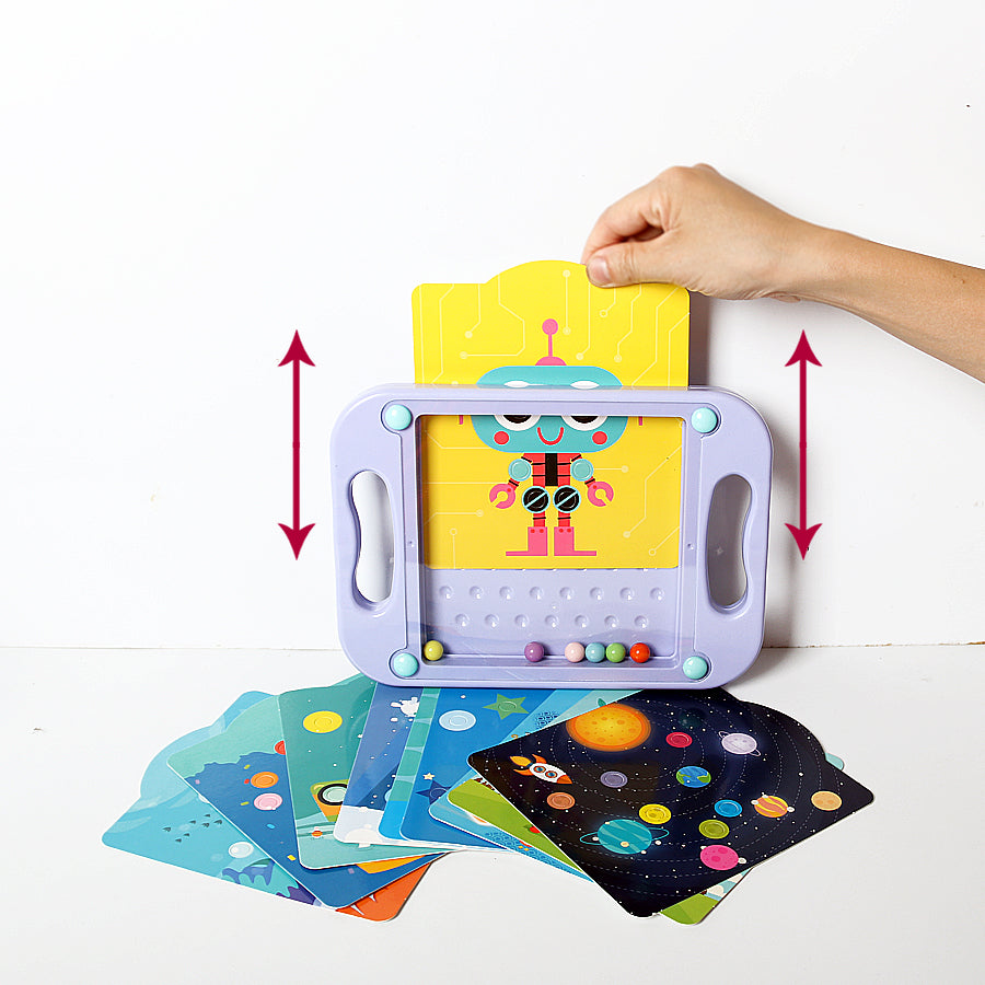 Hand sliding a yellow robot card into a purple maze board, with other illustrated cards below