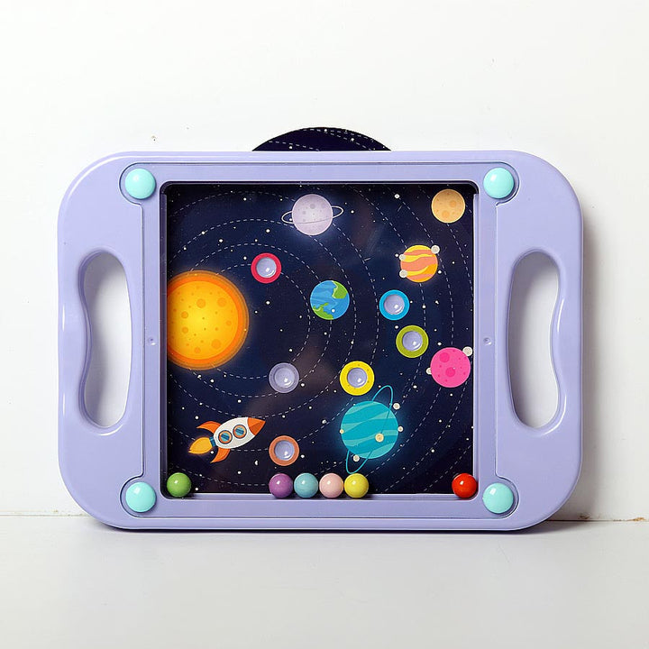 Purple handheld maze board with a solar system card and colored balls behind a clear front panel