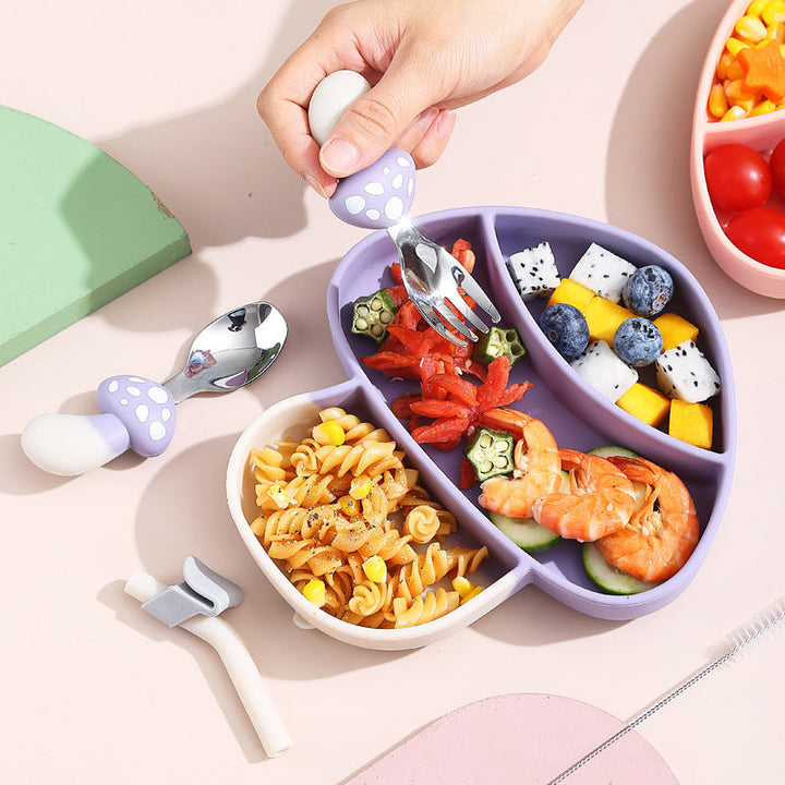 Purple mushroom-shaped divided plate filled with food and paired with mushroom-handled cutlery