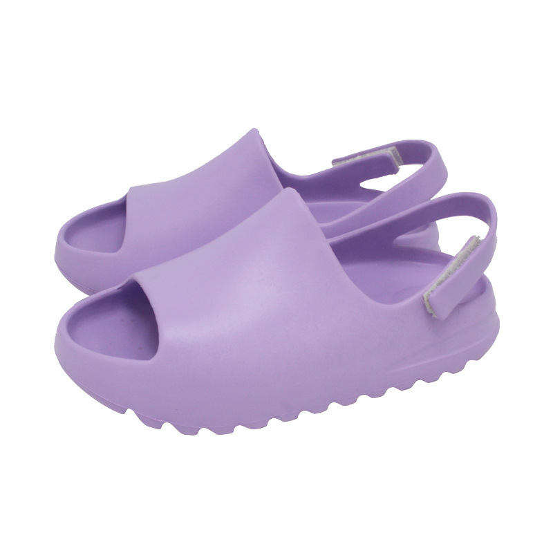 Pair of purple open-toe sandals with adjustable heel straps and ridged sole edges.