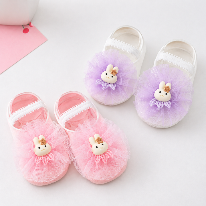 Purple and pink baby socks with bunny decorations and gathered ruffles