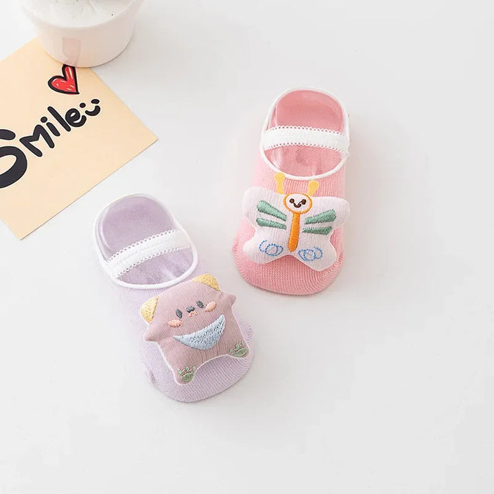 Purple and pink baby socks with raised character and butterfly decorations