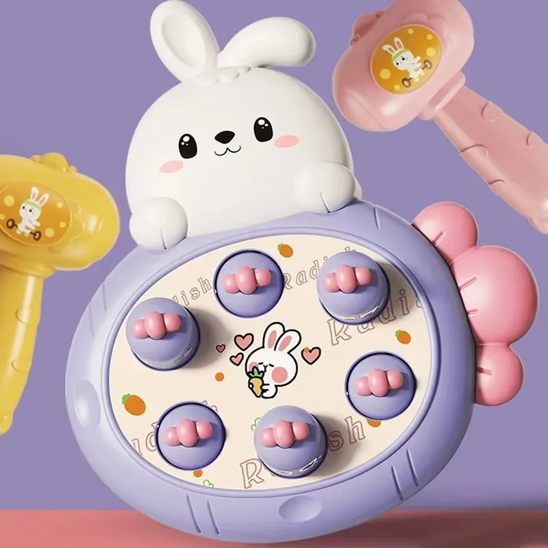 Purple rabbit-themed tapping board with pink-topped targets and colorful hammers