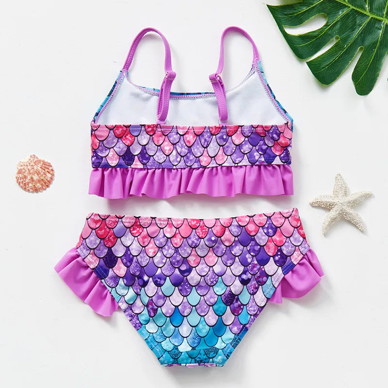 Back of a purple scale-print bikini with thin shoulder straps and ruffled trim.