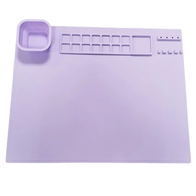 Purple silicone painting mat with a cup, paint wells, and brush holders.