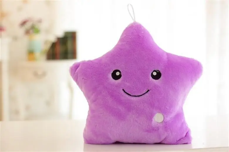 Purple star-shaped plush pillow with a smiling face and round button