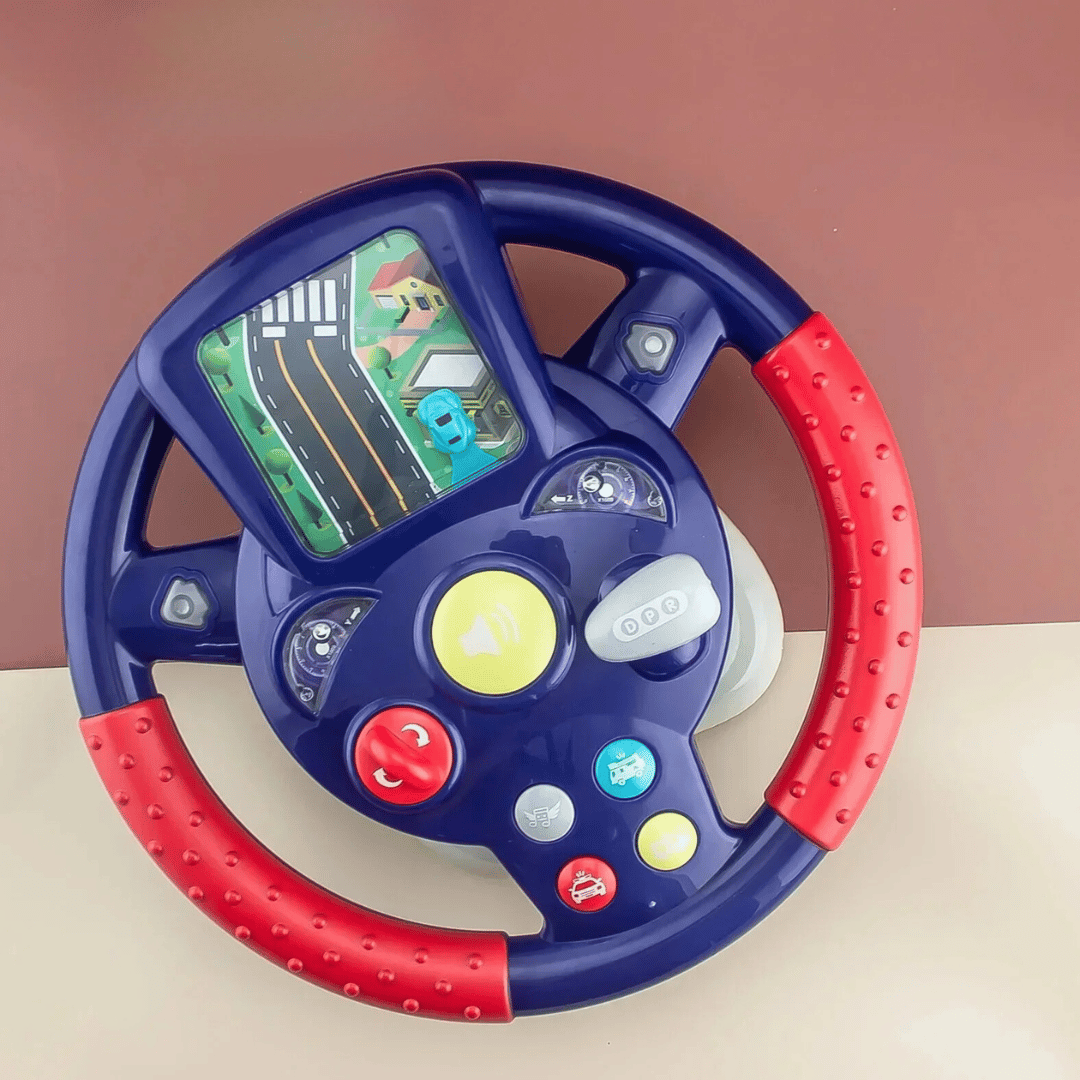 Purple steering wheel toy with red grips and a road scene above the controls