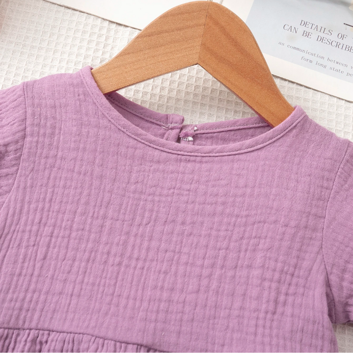 Round neckline and textured cotton fabric on the purple girls&