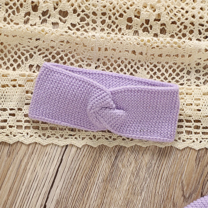 Purple knitted headband with a twisted front detail