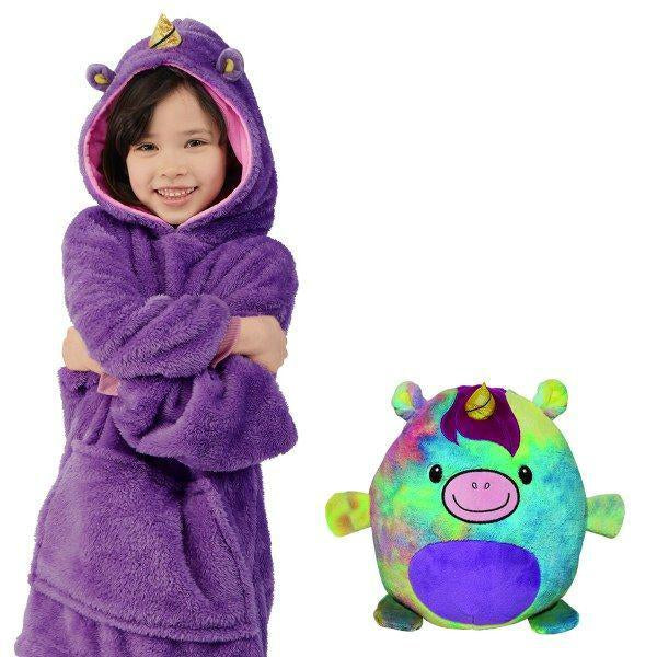 Child wearing the purple unicorn hoodie beside its multicolor unicorn plush toy.