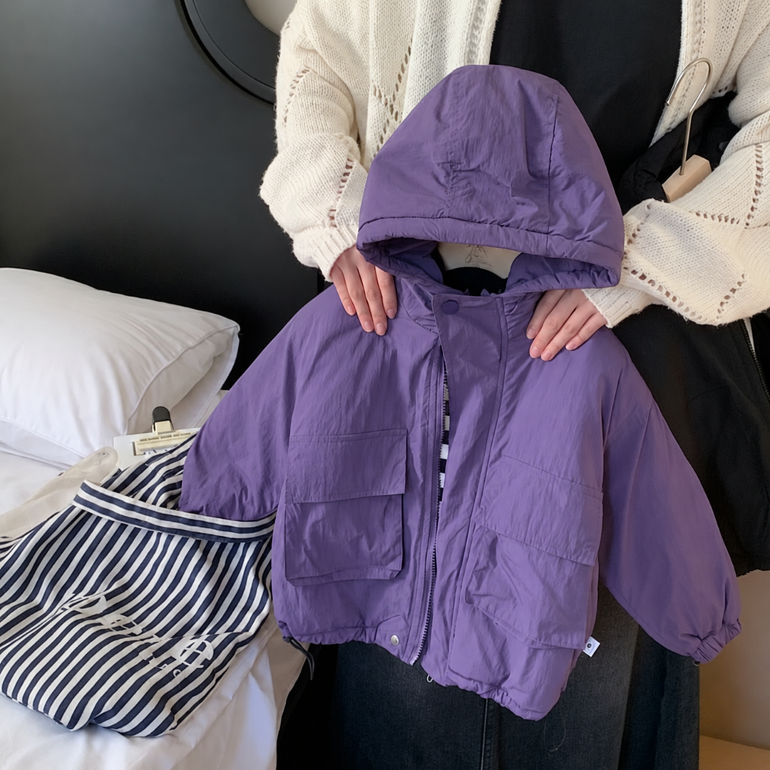 Purple windbreaker held up to show its hood, front closure, and flap pockets