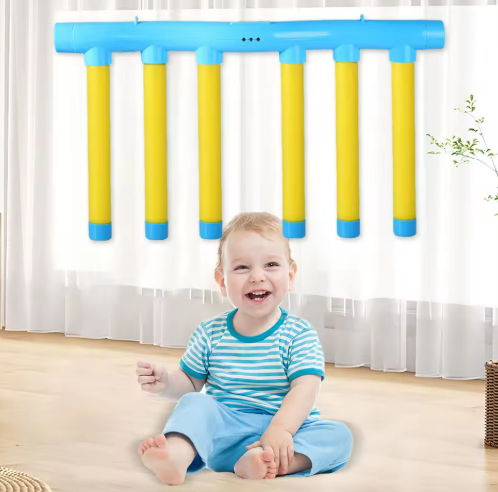 Blue-and-yellow hanging reaction game with six sticks above a seated child