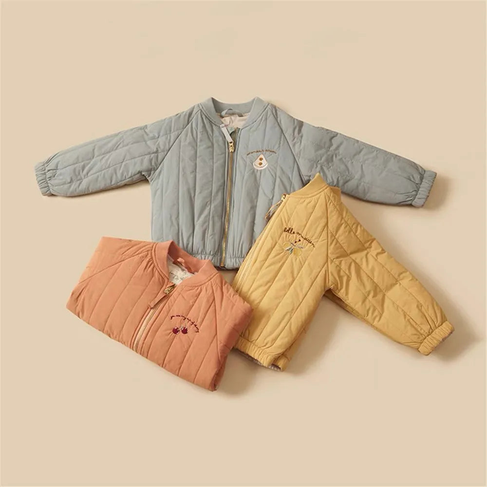 Blue, orange, and yellow quilted cotton winter coats arranged together, showing zip fronts and gathered hems