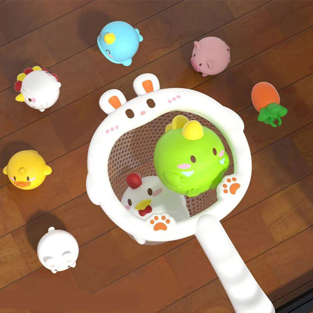 White rabbit-shaped bath net holding colorful animal toys on a wooden surface