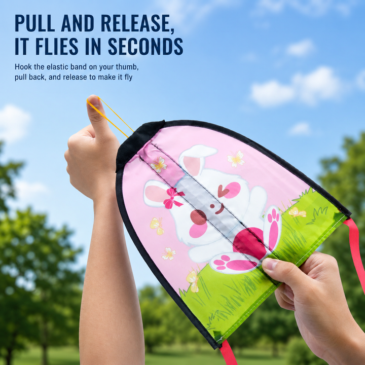 Hands stretching the elastic launch loop on a pink rabbit kite outdoors