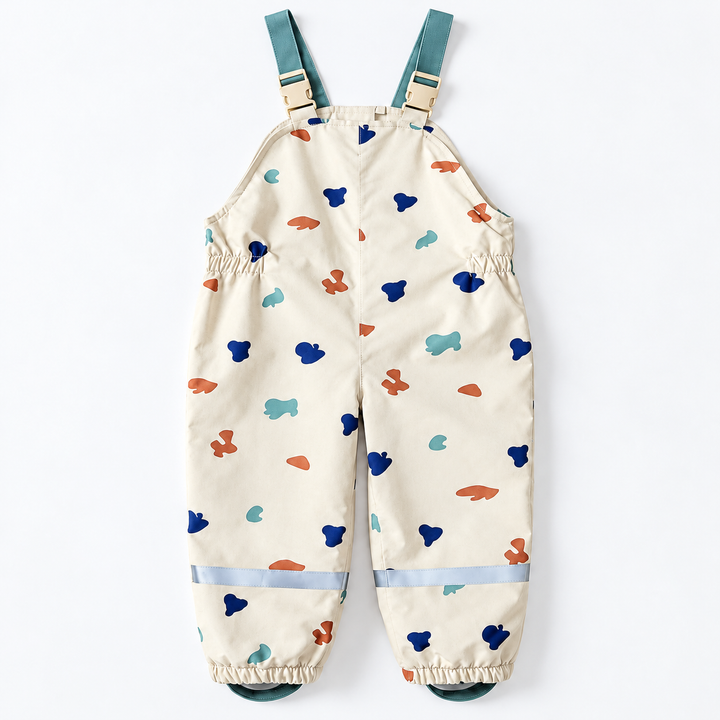 Front view of matching printed bib rain pants with teal shoulder straps and elastic ankles.