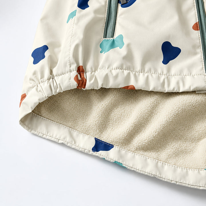 Curved lower hem of the rain jacket showing its cream textured lining.