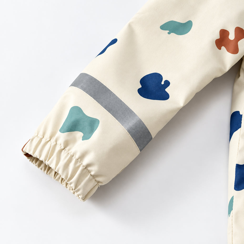 Rain jacket sleeve with colorful shapes, a gray band and an elastic cuff.
