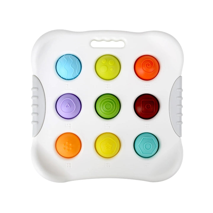 White sensory toy with nine colorful buttons and a top carry opening