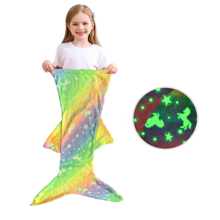 Rainbow mermaid sleeping bag with side fins, shown with a child and a glow-in-the-dark pattern detail.