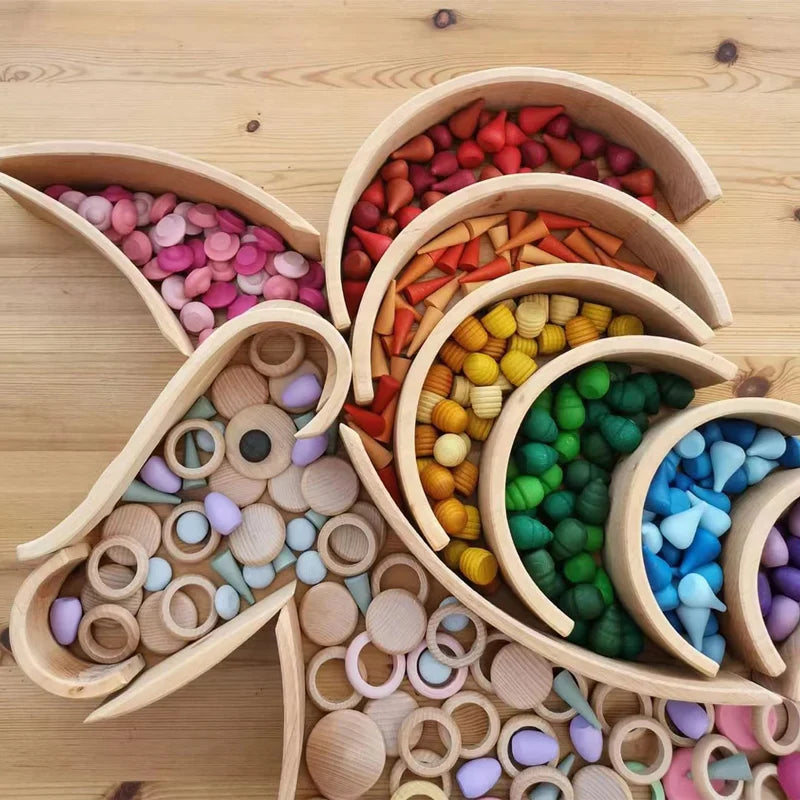 Unicorn-shaped wooden outline filled with rainbow-colored pieces and natural wood rings
